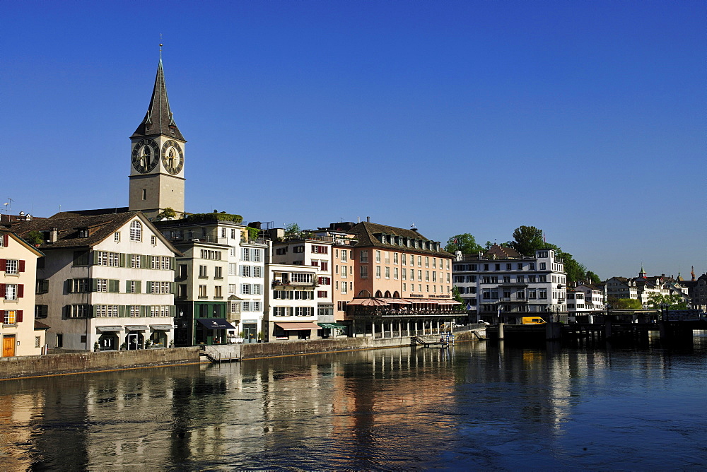 Tower of St. Peter's Church overlooking the rooftops of the historic town centre of Zurich with the Limmat River in the foreground, Zurich, Switzerland, Europe