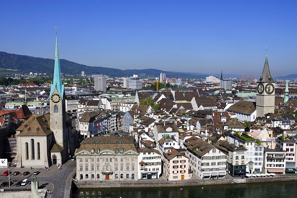 View from a tower of Grossmuenster, Great Minster Church towards the tower of St. Peter Church, the tower of Fraumuenster Church and the River Limmat, Zurich, Switzerland, Europe