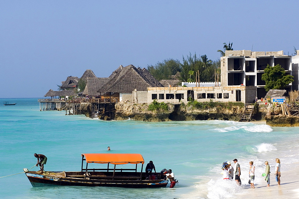 Hotel construction and visitors in Nugwi, Zanzibar, Tanzania, Africa