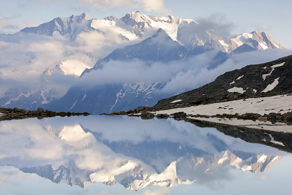 Mt. Hochfeiler reflected in the Friesenbergsee lake, Zillertal Alps, Tyrol, Austria, Europe