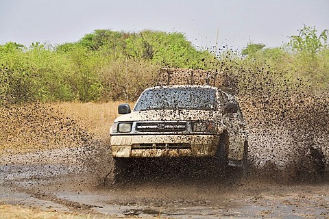 Four-wheel drive car driving through mud and water, Moremi National Park, Moremi Wildlife Reserve, Okavango Delta, Botswana, Africa