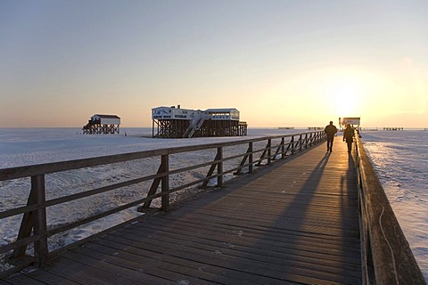 Winterly snow-covered sea bridge in St Peter-Ording on the North Sea, Eiderstedt Peninsula, Nordfriesland, Schleswig-Holstein, Northern Germany, Germany, Europe