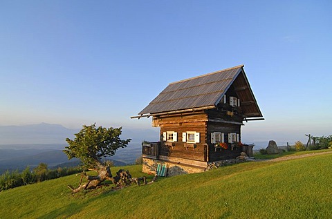 A cabin on Magdalensberg mountain illuminated by soft early morning light, Carinthia, Austria, Europe