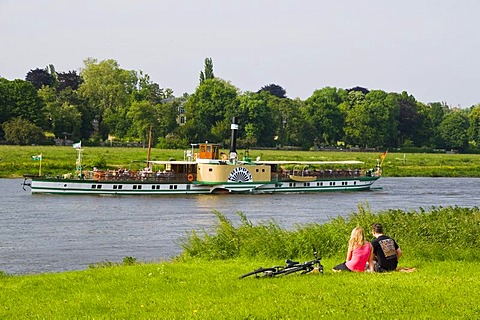 Couple on the shore of the river Elbe, paddle wheel steamer, Dresden, Saxony, Germany