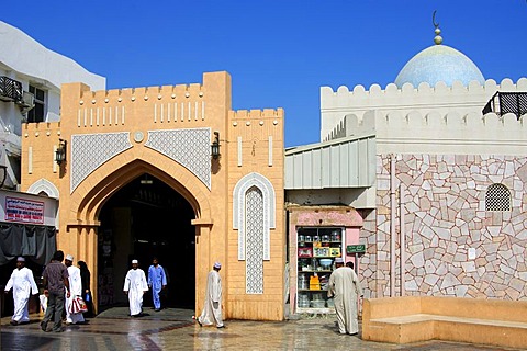 Local residents dressed in traditional clothes at the entrance gate to Souq Muttrah markets, Muscat, Oman, the Near East