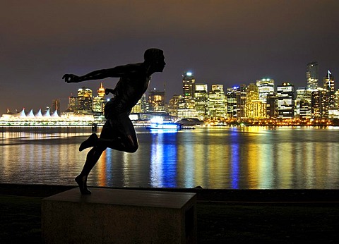 Skyline in front of Coral Harbour, at dusk, and the statue 'the runner', Vancouver, British Columbia, Canada, North America