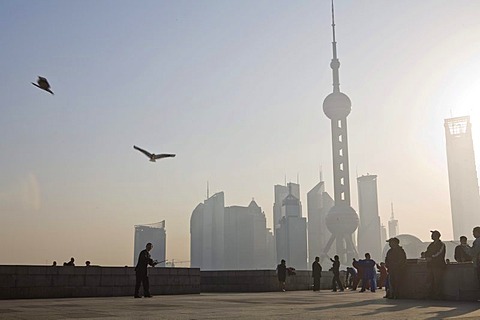 People flying kites at the Bund, in front of the Pudong Skyline, Shanghai, China, Asia