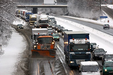 Snow plough in operation, traffic jam after heavy snow fall, motorway Autobahn A40, Ruhr expressway between Duisburg and Essen, near Muelheim, North Rhine-Westphalia, Germany, Europe