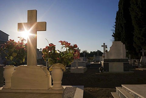 Graves with the sun rising behind them