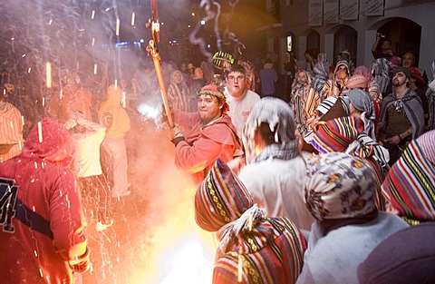 During the Correfoc or Fire Run, hooded Fire Devils run through the streets of Spanish towns brandishing fireworks, Altea, Costa Blanca, Spain, Europe