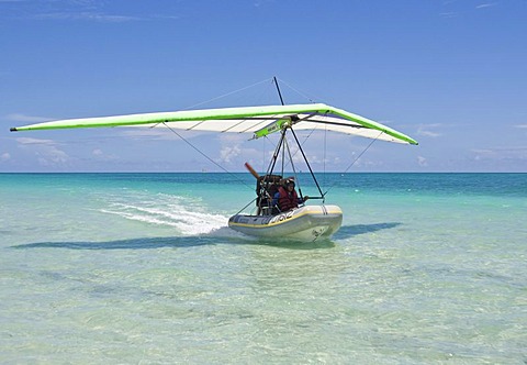 Motorised hang glider landing on the sea, UL-Trike, Ultra Light airplane with a life boat, Varadero, Cuba, Caribbean, Central America, America