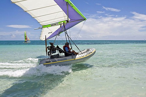 Motorised hang glider landing on the sea, UL-Trike, Ultra Light airplane with a life boat, Varadero, Cuba, Caribbean, Central America, America