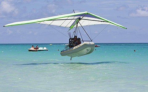 Motorised hang glider landing on the sea, UL-Trike, Ultra Light airplane with a life boat, Varadero, Cuba, Caribbean, Central America, America