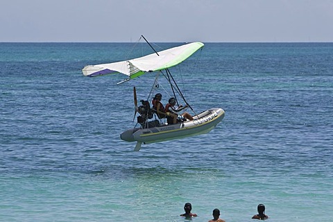 Motorised hang glider landing on the sea, UL-Trike, Ultra Light airplane with a life boat, Varadero, Cuba, Caribbean, Central America, America