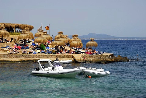 Small boats in front of a sun terrace on the Mediterranean coast, Playa, Platja de Ses Illetes, tourism in a bay west of Palma de Majorca, Balearic Islands, Spain, Europe