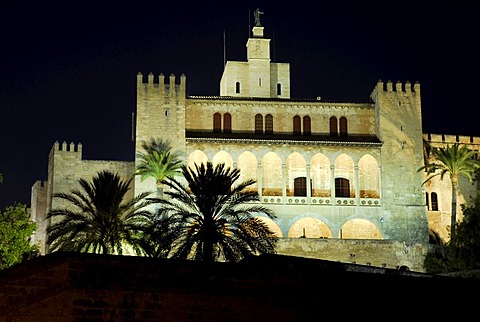 Illuminated Almudaina Palace in the evening, Palau de Almudaina, historic castle with palm trees in the historic centre, Ciutat Antiga, Palma de Majorca, Balearic Islands, Spain, Europe