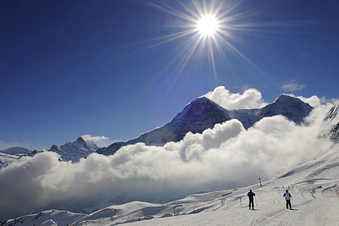 Skier on the Mt Maennlichen with view of Mt Wetterhorn, Mt Eiger, Mt Moench, Grindelwald, Bernese Alps, Switzerland, Europe