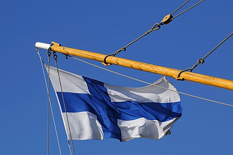 Finnish flag on a sailing ship in the port of Helsinki, Finland, Europe