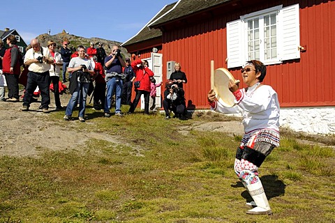 Inuit wearing a traditional costume, folklore in front of a museum in Tasiilaq, Ammassalik, East Greenland, Greenland