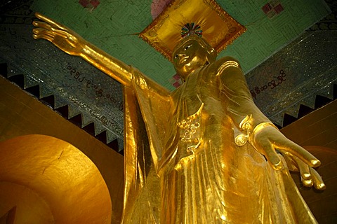 Large standing golden Buddha statue with outstreched arm and pointing finger, shrine on Mandalay Hill, Birma, Burma, Myanmar, South Asia