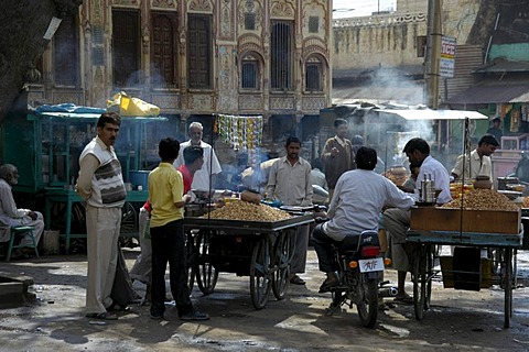 Street scene, men standing around smokey food stands, Lachmangarh, Rajasthan, India, Asia