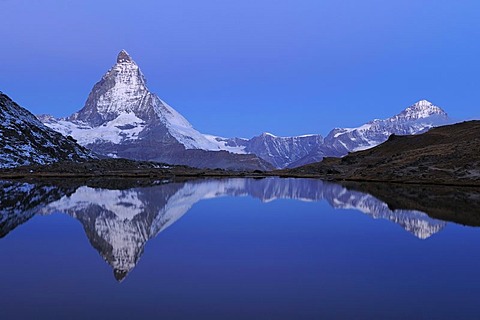 Matterhorn reflecting in Riffelsee in Zermatt, Wallis, Switzerland, Europe