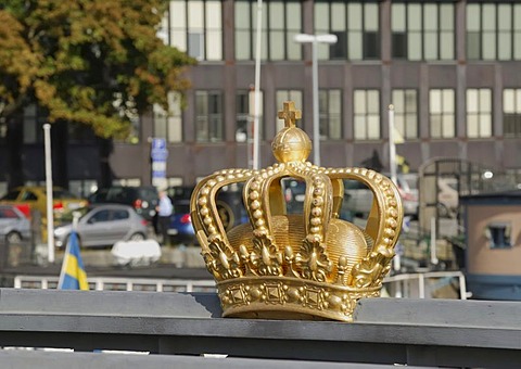 Golden Swedish crown on the handrail of the bridge between the two islands Blasieholmen and Skeppsholmen, Stockholm, Sweden, Scandinavia, Europe