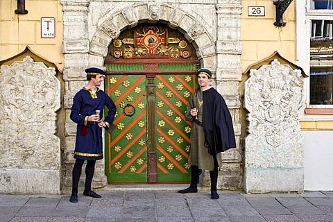 Actors wearing traditional costume in front of the House of the Blackheads in the historic centre of Tallinn, Estonia, Baltic States, North Europe