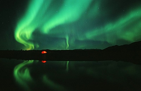 Aurora Borealis and illuminated tent, Alaska, USA