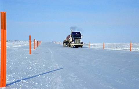 Truck driving on an ice road, built by oil companies and used to connect individual oil drilling sites in winter, Prudhoe Bay, Alaska, USA