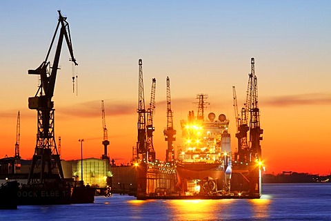 Ship in a dock of the Blohm and Voss shipyard in the port of Hamburg in evening light, Elbe River, Hamburg, Germany, Europe