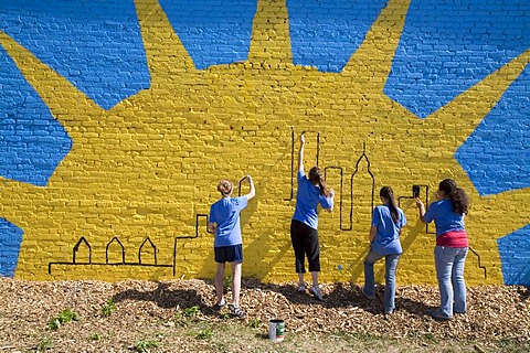 Volunteers in the Summer in the City program, a community improvement project, painting a mural on a building, Detroit, Michigan, USA