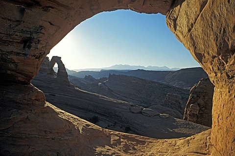 Delicate Arch, left, and the distant La Sal Mountains, framed by another small arch, Arches National Park, Utah, USA