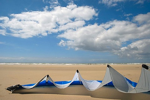 Kite sail lying on the sand of a beach in Brittany, France, Europe