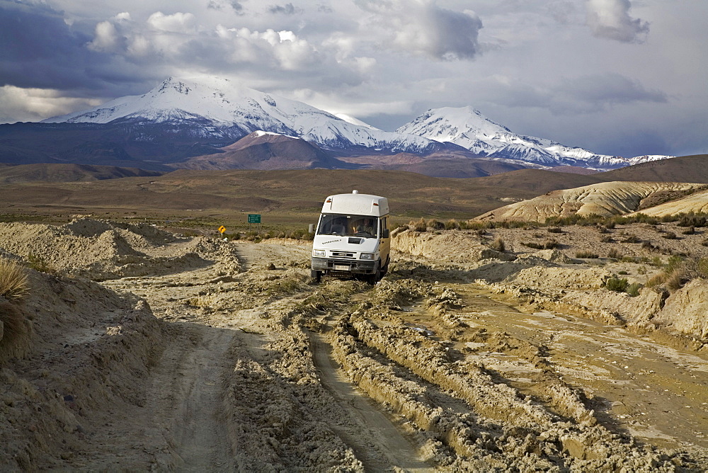 Camper on a destructed road from the rain in national park Lauca on the way to national park Reserva Nacional Las Vicunas, Chile, South America