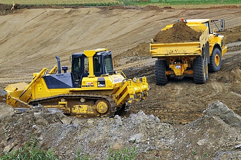 Crawler-type vehicle and truck on a building site