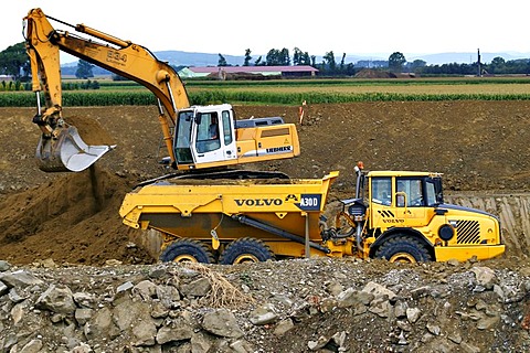 Crawler-type vehicle and truck on a building site