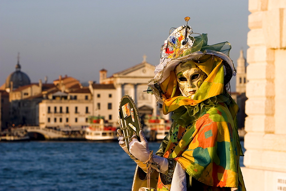 Mask in evening light at the carnival, Venice, Italy