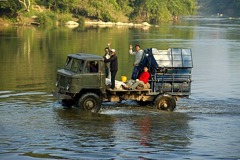 Old lorry drives through water Vang Vieng Laos