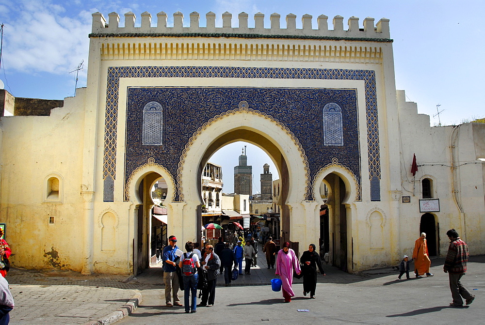 People walk through the beautiful oriental gate into the city center, Bab Bou Jeloud, Fes El-Bali Morocco