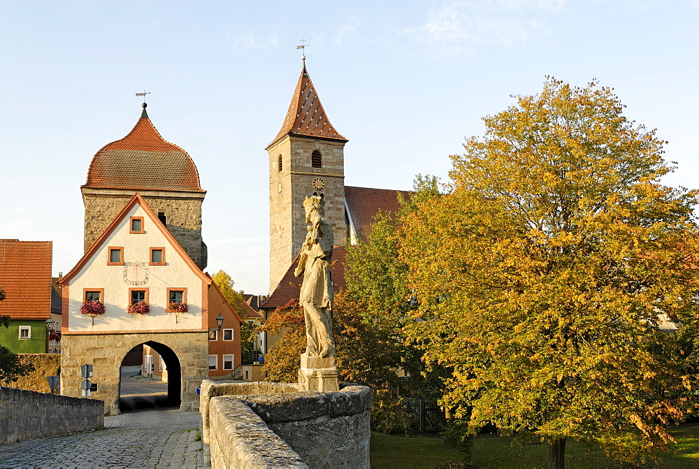 Ornbau Middle Franconia Bavaria Germany bridge across the river Altmuehl town gate and parish church St Jakobus