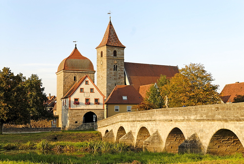 Ornbau Middle Franconia Bavaria Germany bridge across the river Altmuehl town gate and parish church St Jakobus