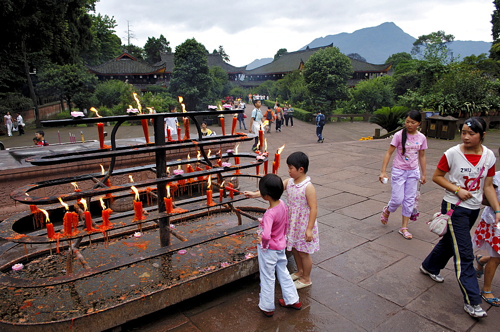 Children give votive candles, Wannian monastery, Mount Emei near Chengdu, China, Asia