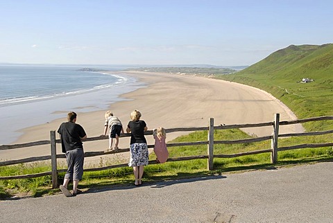 Family overlooking the beach and sea at a lookout point, Rhossili Beach, Gower Peninsula, Wales, Great Britain, Europe