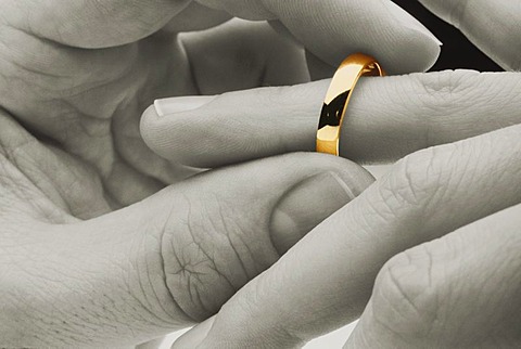 Putting a wedding ring on a finger