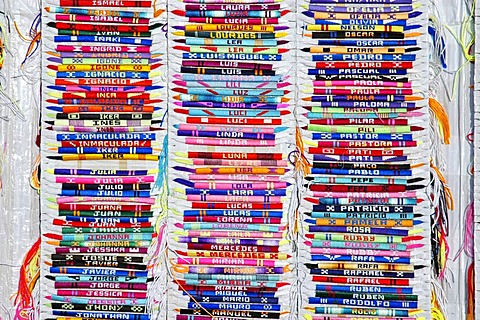 Colourful bracelets from cloth with names are being sold at a fleamarket in Spain, friendship bracelets