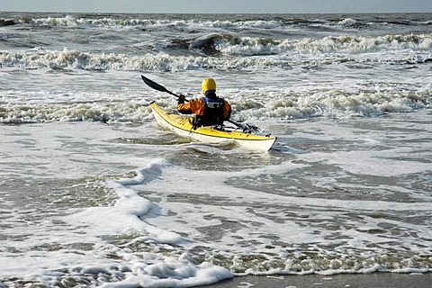 Man in yellow kajak is entering the sea, Katwijk aan Zee, South Holland, Holland, The Netherlands