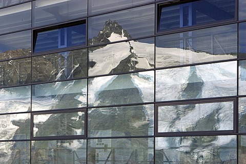 Reflection of mountain Grossglockner on glass front of parking house on Franz Josefs Hohe Carinthia Austria