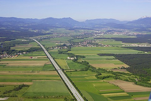 Aerial shot of the South freeway (A2) over the town Neunkirchen to the Rax mountain range, Foehrenau, Lower Austria, Austria
