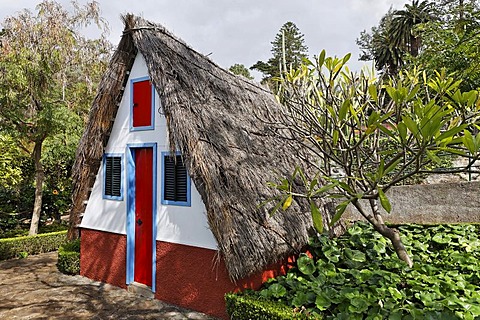 A typical house in the Santana style with a straw covered roof in the botanical garden, Funchal, Madeira, Portugal